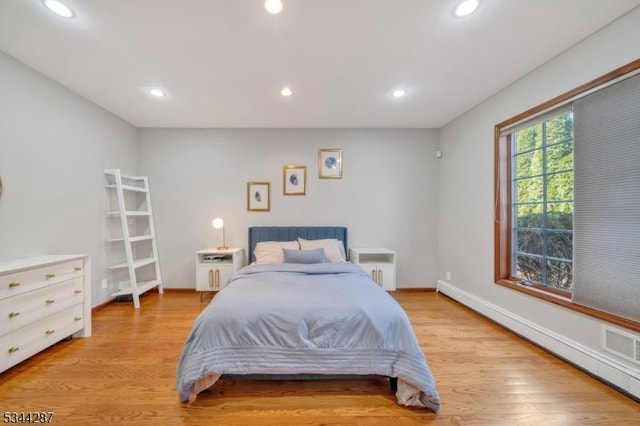bedroom with recessed lighting, baseboards, light wood finished floors, and a baseboard radiator