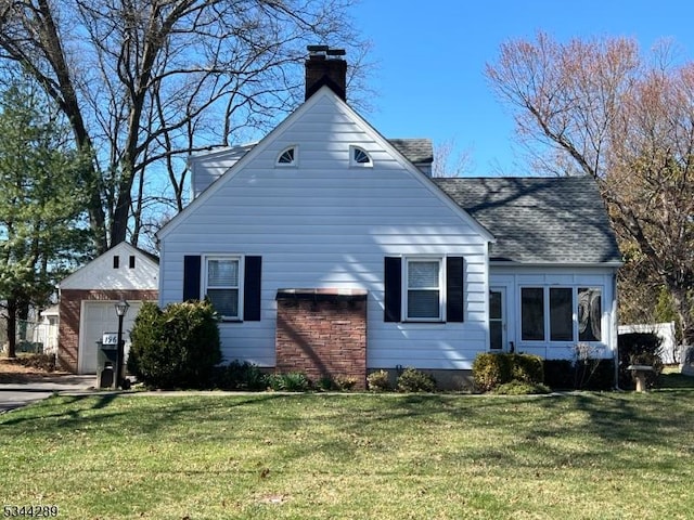 view of property exterior with a detached garage, a lawn, a shingled roof, and a chimney