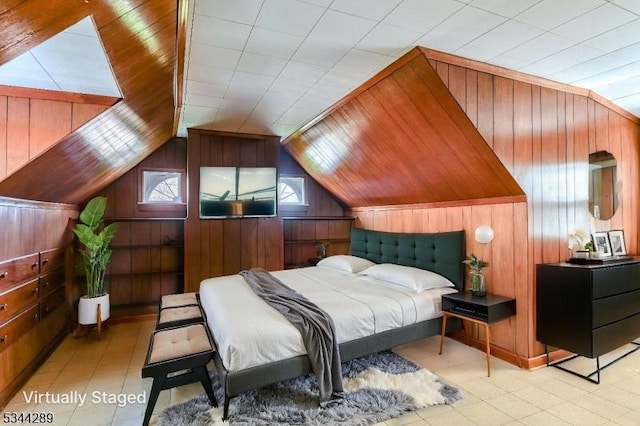 bedroom with wooden walls and lofted ceiling