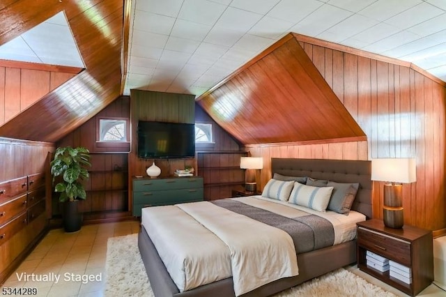 bedroom with wood walls and vaulted ceiling