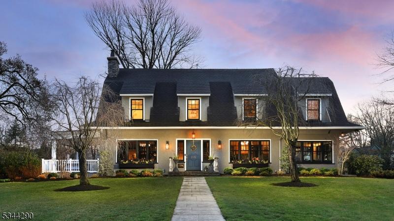 215 Orchard St, Cranford Twp, NJ 07016 - view of front of house with stucco siding, a chimney, and a yard
