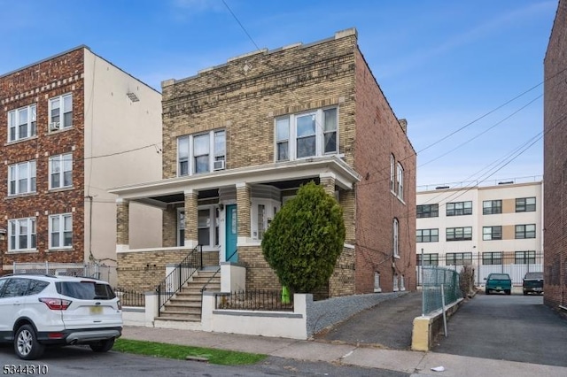 multi unit property with brick siding and fence