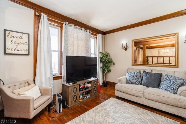 living room featuring baseboards, wood finished floors, and ornamental molding