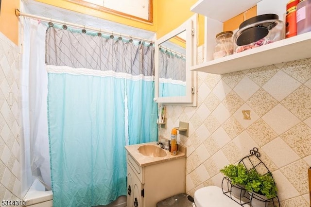 full bathroom with vanity, shower / tub combo, and toilet