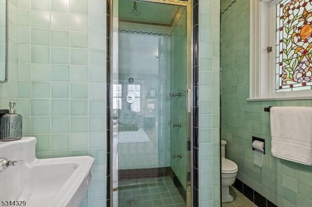 274 Ridgewood Ave, Glen Ridge Boro Twp, NJ 07028 - bathroom with tile walls, toilet, a stall shower, and tile patterned flooring