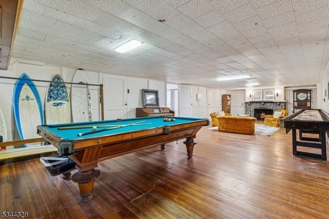 274 Ridgewood Ave, Glen Ridge Boro Twp, NJ 07028 - playroom with billiards table, a stone fireplace, and hardwood / wood-style flooring
