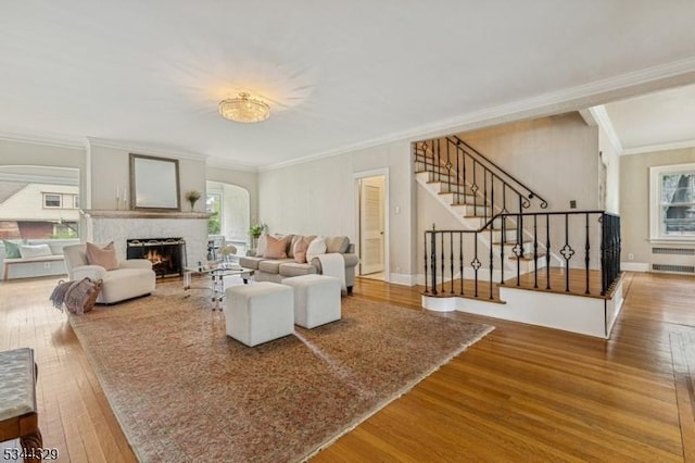 274 Ridgewood Ave, Glen Ridge Boro Twp, NJ 07028 - living area with wood finished floors, stairs, ornamental molding, a warm lit fireplace, and baseboards