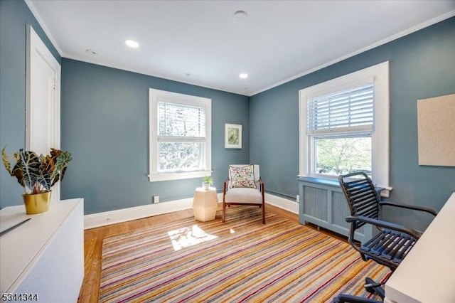 office area featuring a healthy amount of sunlight, baseboards, ornamental molding, and wood finished floors