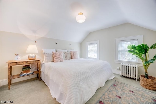 bedroom with baseboards, vaulted ceiling, light carpet, and radiator heating unit