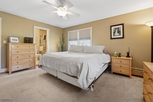 bedroom featuring light carpet, baseboards, ceiling fan, a baseboard heating unit, and ensuite bath