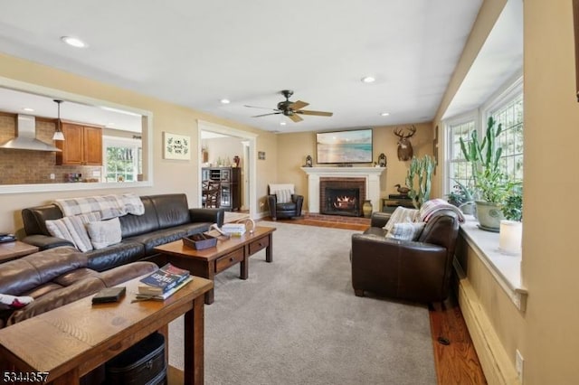 living room featuring recessed lighting, ceiling fan, plenty of natural light, and a fireplace