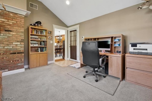 home office with an inviting chandelier, light carpet, baseboards, lofted ceiling, and visible vents