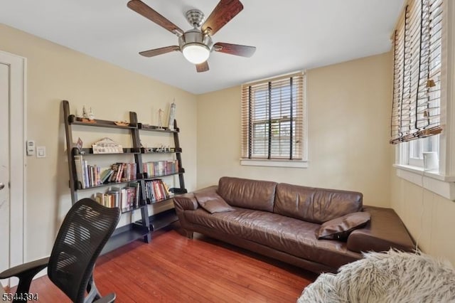 living room with wood finished floors and ceiling fan