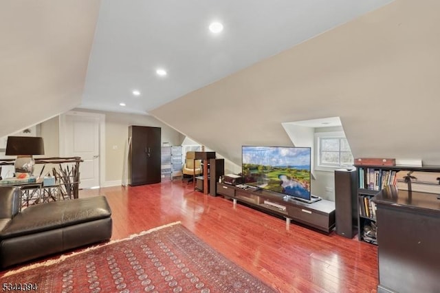 living room with recessed lighting, vaulted ceiling, and wood finished floors