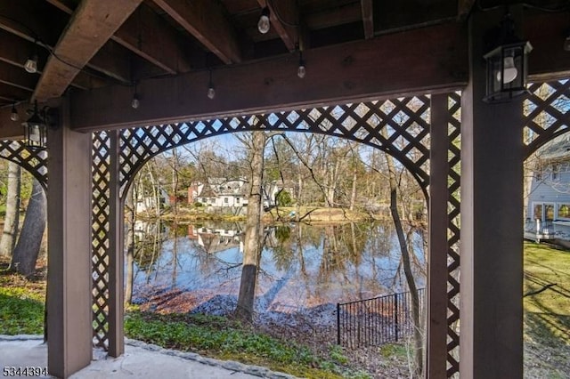 exterior space with fence and a water view