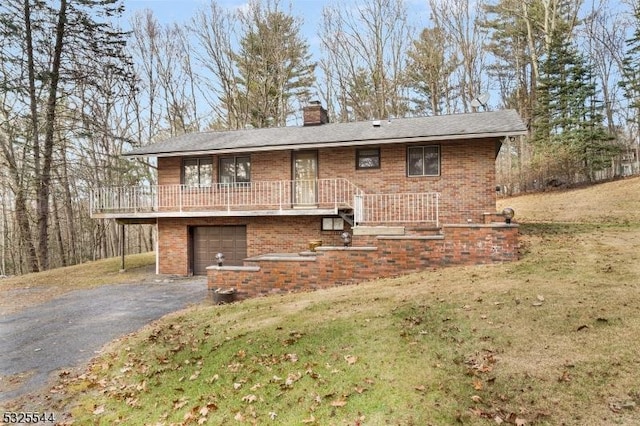 159 US Highway 206, Sandyston Twp, NJ 07826 - rear view of property featuring brick siding, a garage, a chimney, and aphalt driveway
