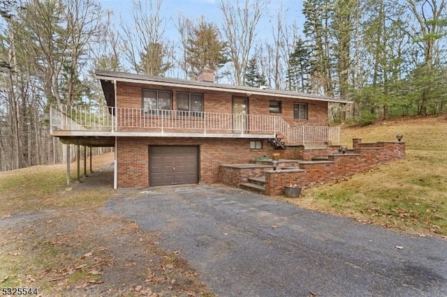 159 US Highway 206, Sandyston Twp, NJ 07826 - bi-level home featuring covered porch, a chimney, brick siding, an attached garage, and driveway