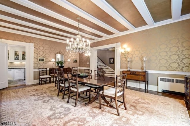 dining room featuring radiator, stairs, beam ceiling, wallpapered walls, and a chandelier
