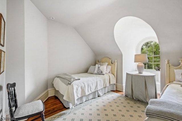 bedroom with light wood-style flooring and lofted ceiling