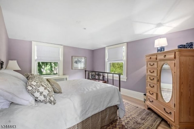 bedroom featuring baseboards and light wood-style floors