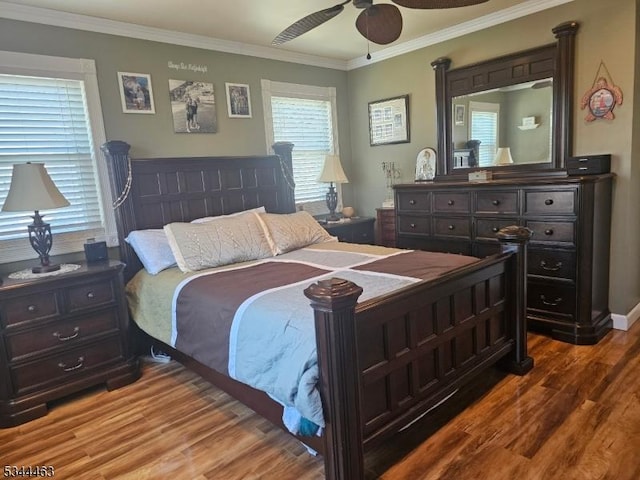 bedroom featuring ornamental molding, baseboards, ceiling fan, and wood finished floors