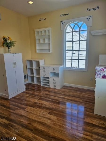 interior space featuring recessed lighting, baseboards, and wood finished floors