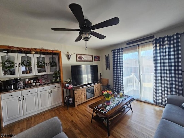 living room with wood finished floors and ceiling fan