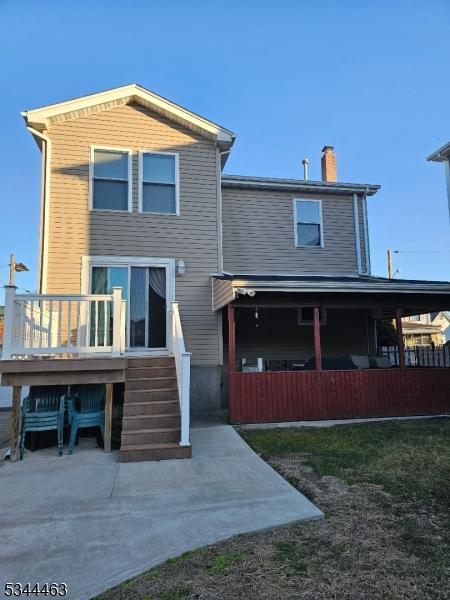 rear view of house featuring a chimney