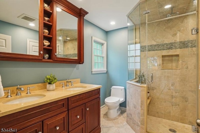 bathroom featuring a stall shower, toilet, and double vanity