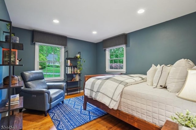 bedroom with wood finished floors, multiple windows, and recessed lighting