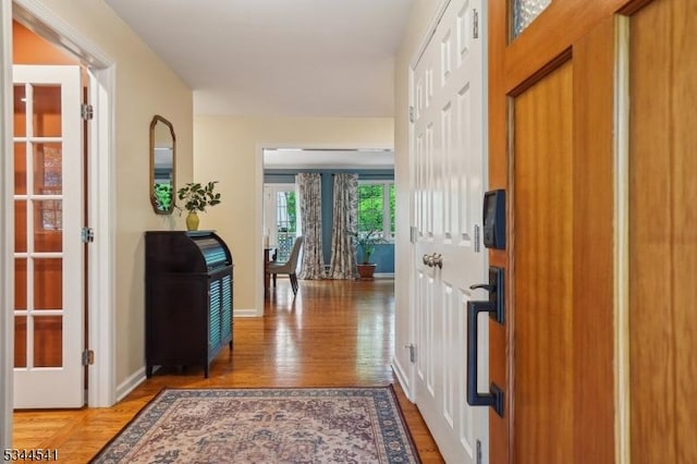 entryway with light wood-type flooring and baseboards