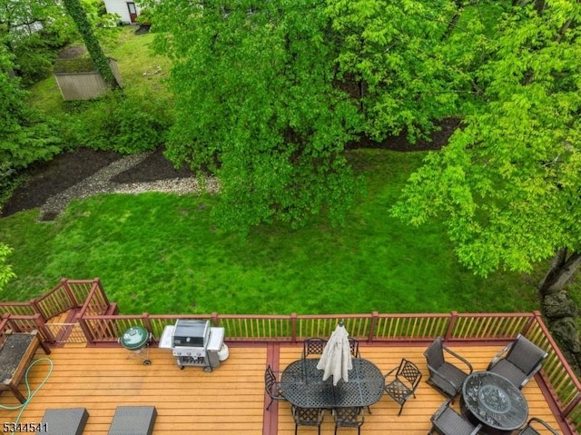wooden terrace featuring a grill