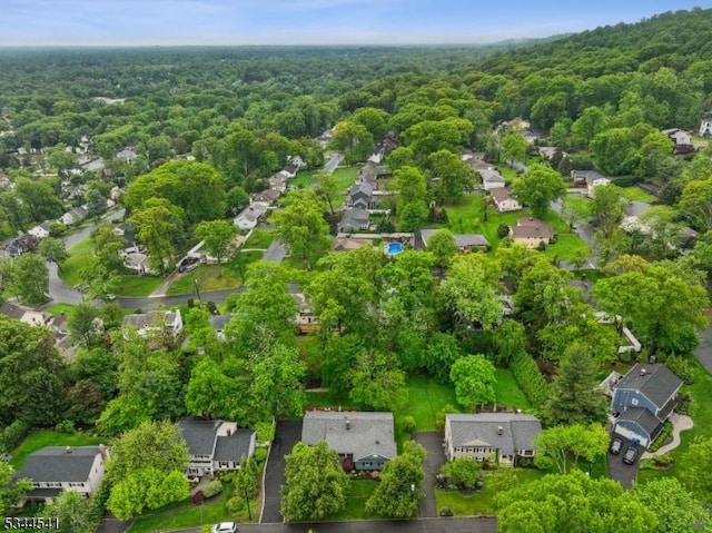 aerial view of residential area with a heavily wooded area