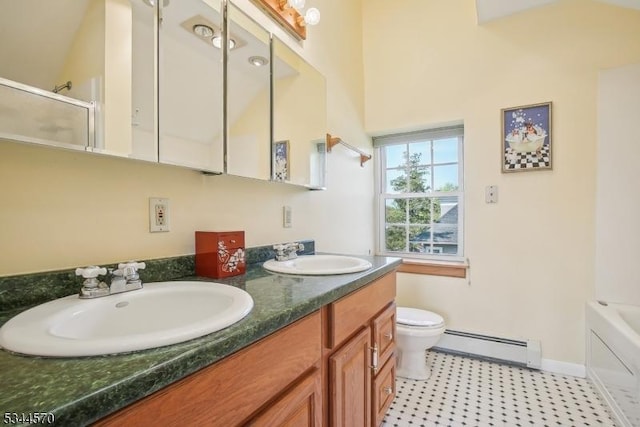 full bath with double vanity, an enclosed shower, baseboard heating, a sink, and toilet