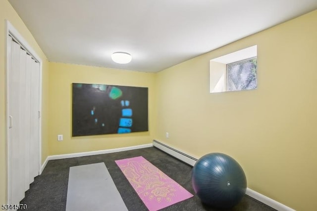 workout room with baseboards and a baseboard heating unit