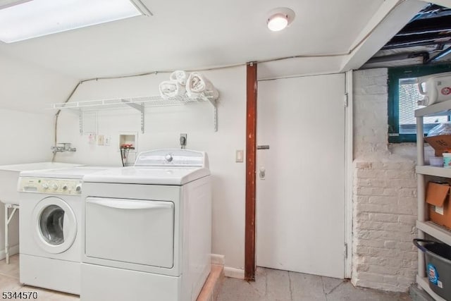 clothes washing area featuring independent washer and dryer and laundry area