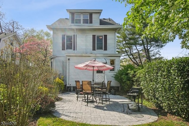 rear view of property featuring a patio