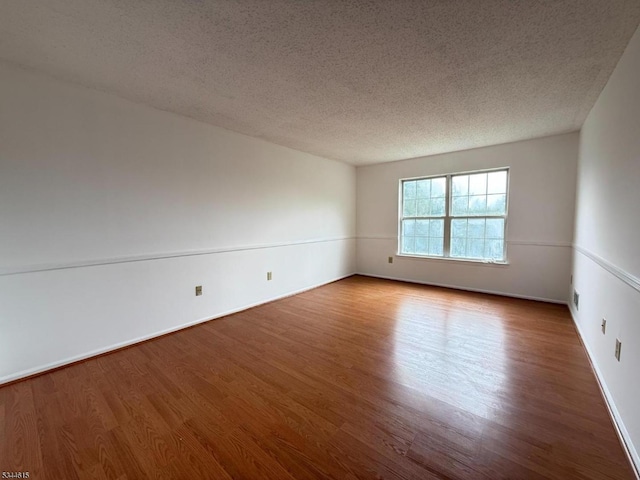 404 Azalea Ter, Branchburg Twp, NJ 08876 - spare room with wood finished floors and a textured ceiling