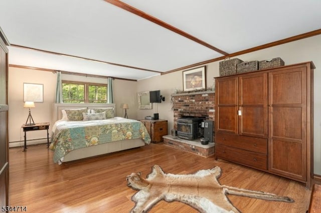 23 Devita Rd, Sandyston Twp, NJ 07826 - bedroom featuring crown molding, a wood stove, light wood finished floors, and baseboard heating
