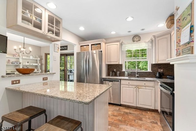 23 Devita Rd, Sandyston Twp, NJ 07826 - kitchen with appliances with stainless steel finishes, a breakfast bar area, decorative backsplash, glass insert cabinets, and recessed lighting