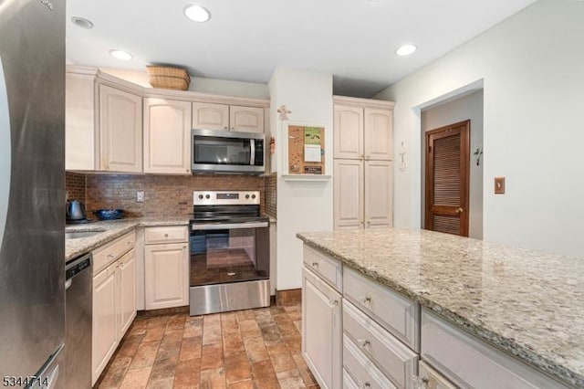 23 Devita Rd, Sandyston Twp, NJ 07826 - kitchen with appliances with stainless steel finishes, decorative backsplash, light stone countertops, recessed lighting, and light stone finish floors