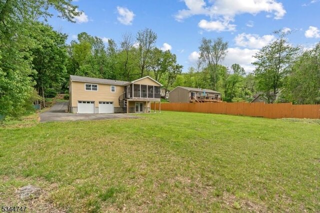 75 Shore Rd, Green Twp, NJ 07821 - rear view of property featuring a sunroom, an attached garage, driveway, and stairway