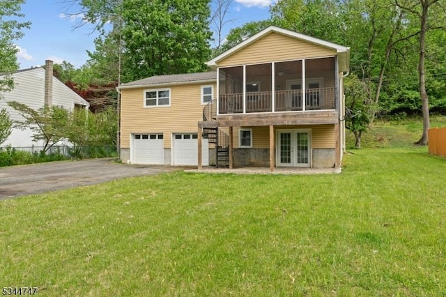 75 Shore Rd, Green Twp, NJ 07821 - back of house with french doors, asphalt driveway, a sunroom, an attached garage, and a lawn