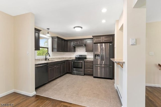 75 Shore Rd, Green Twp, NJ 07821 - kitchen featuring stainless steel appliances, a sink, under cabinet range hood, light stone counters, and dark brown cabinetry