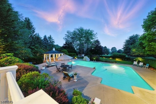 2 Wakefield Dr, Washington Twp, NJ 07840 - pool at dusk featuring a patio, an outdoor pool, a gazebo, and view of scattered trees