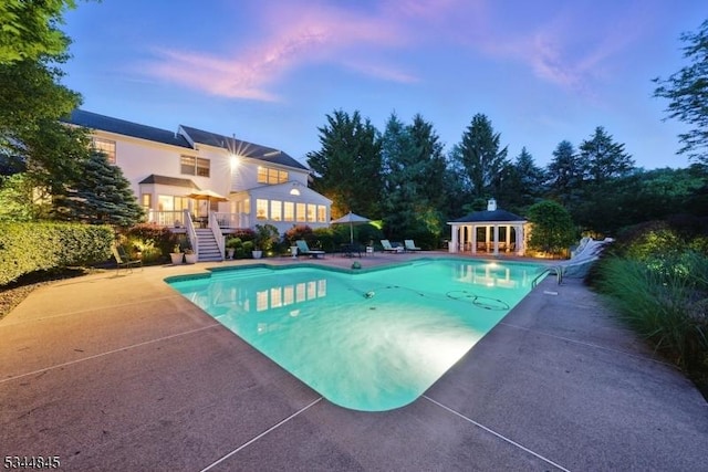 2 Wakefield Dr, Washington Twp, NJ 07840 - pool at dusk with an outdoor pool, stairs, a patio, and an outdoor structure