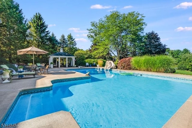 2 Wakefield Dr, Washington Twp, NJ 07840 - swimming pool featuring a gazebo, a water slide, a patio area, and view of wooded area