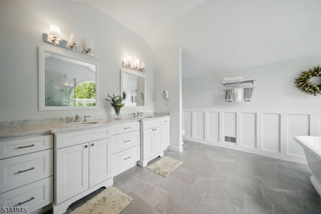 2 Wakefield Dr, Washington Twp, NJ 07840 - bathroom with vaulted ceiling, double vanity, a soaking tub, wainscoting, and a shower
