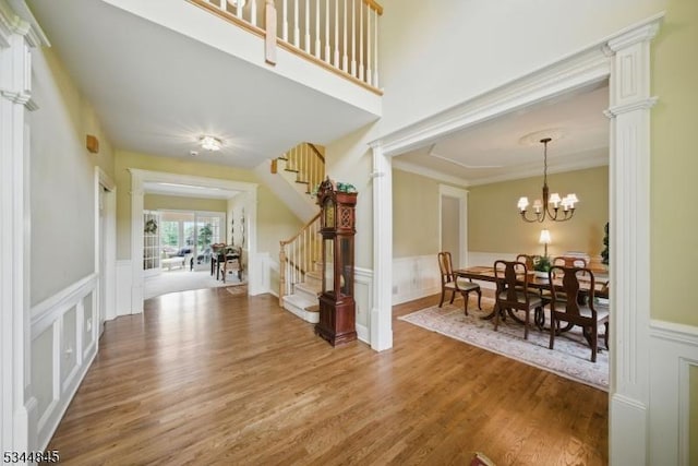 2 Wakefield Dr, Washington Twp, NJ 07840 - foyer featuring stairs, a decorative wall, wainscoting, light wood-style flooring, and a chandelier