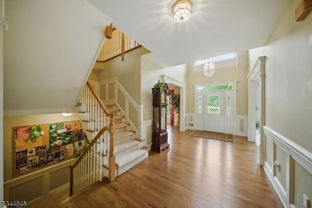 2 Wakefield Dr, Washington Twp, NJ 07840 - foyer featuring a decorative wall, wood finished floors, a towering ceiling, stairway, and wainscoting